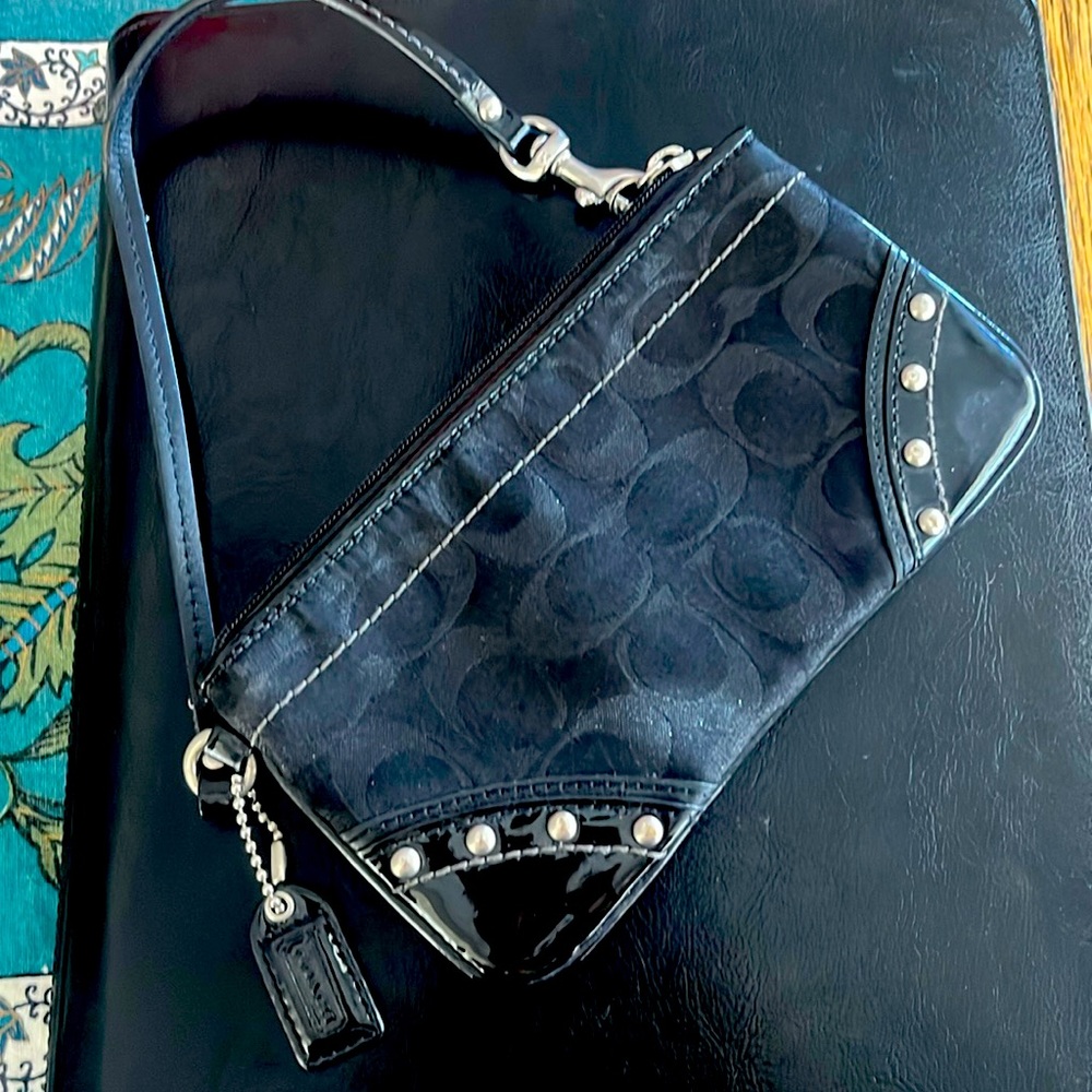 Coach handheld small black clutch with strap.